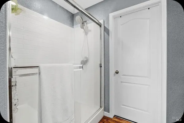 a bathroom with a glass door shower