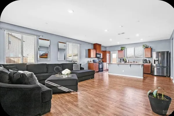 a living room with furniture and wooden floor