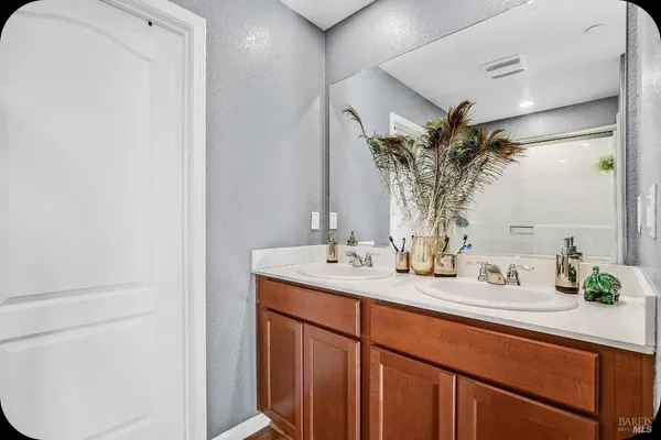a bathroom with a double vanity sink and a mirror