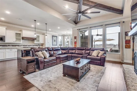 a kitchen with stainless steel appliances granite countertop a stove a refrigerator a oven a sink with a dining table and chairs
