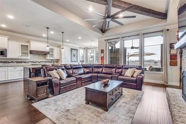 a kitchen with stainless steel appliances granite countertop a stove a refrigerator a oven a sink with a dining table and chairs