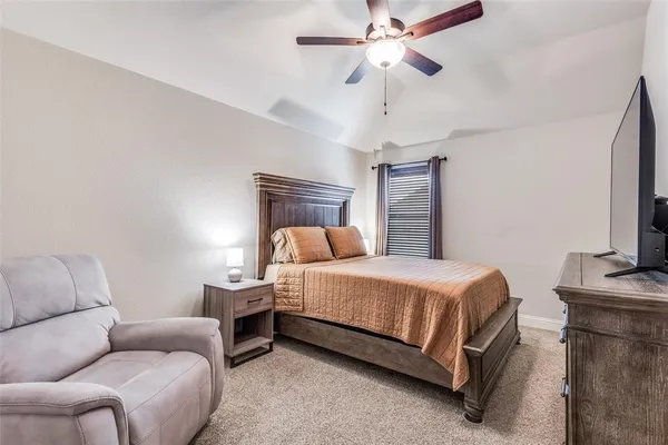 a bathroom with a granite countertop toilet a sink and a mirror