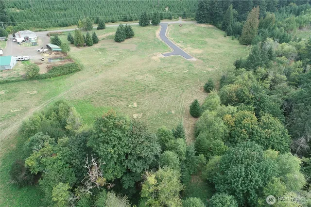a view of a wooden house with a yard