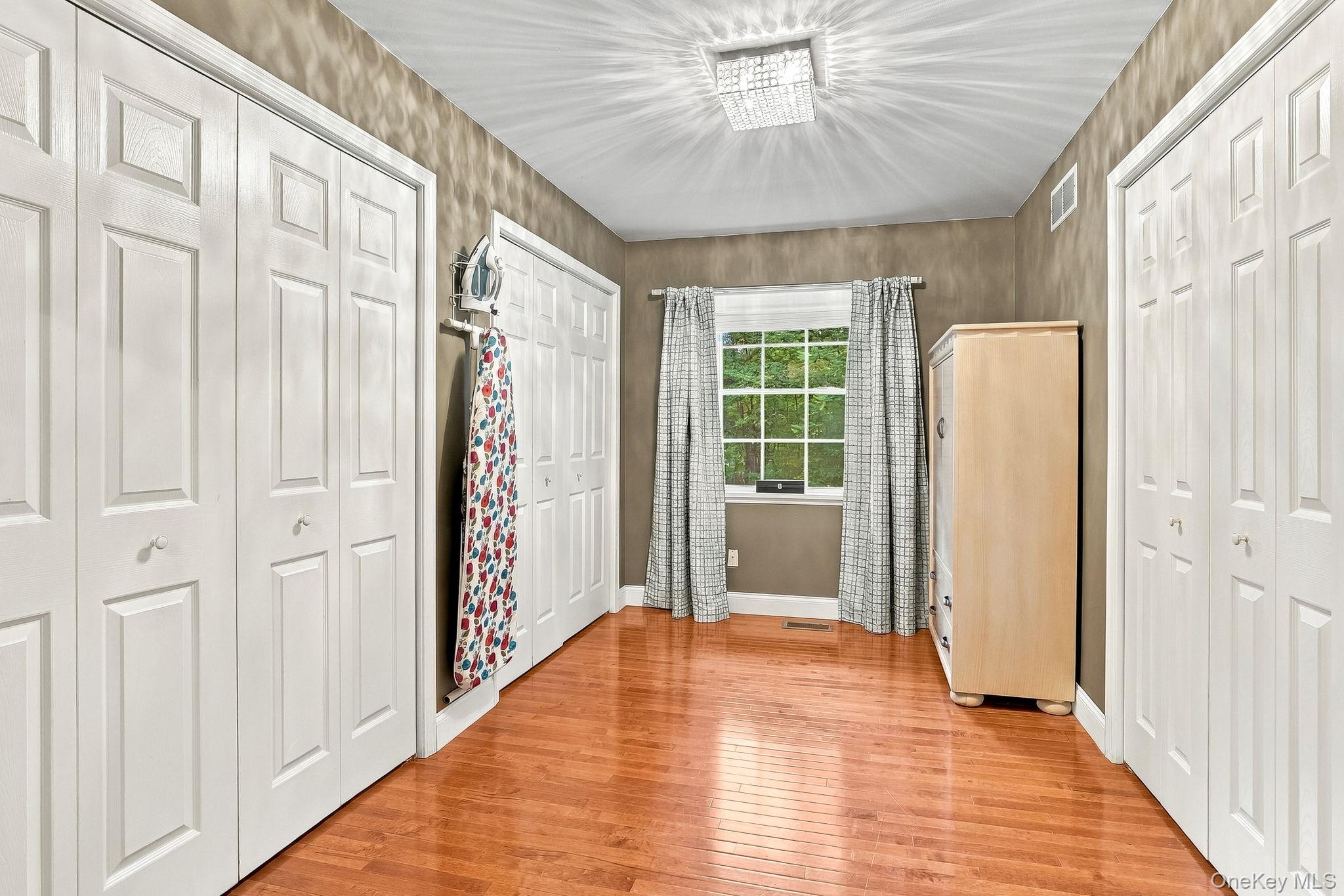 48 Mac Farlane Road Wappingers Falls, NY 12590 - Photo 28 of 47 Hardwood-flooring, multiple paneled doors, single window, and a ceiling-mounted light fixture-Primary Closet