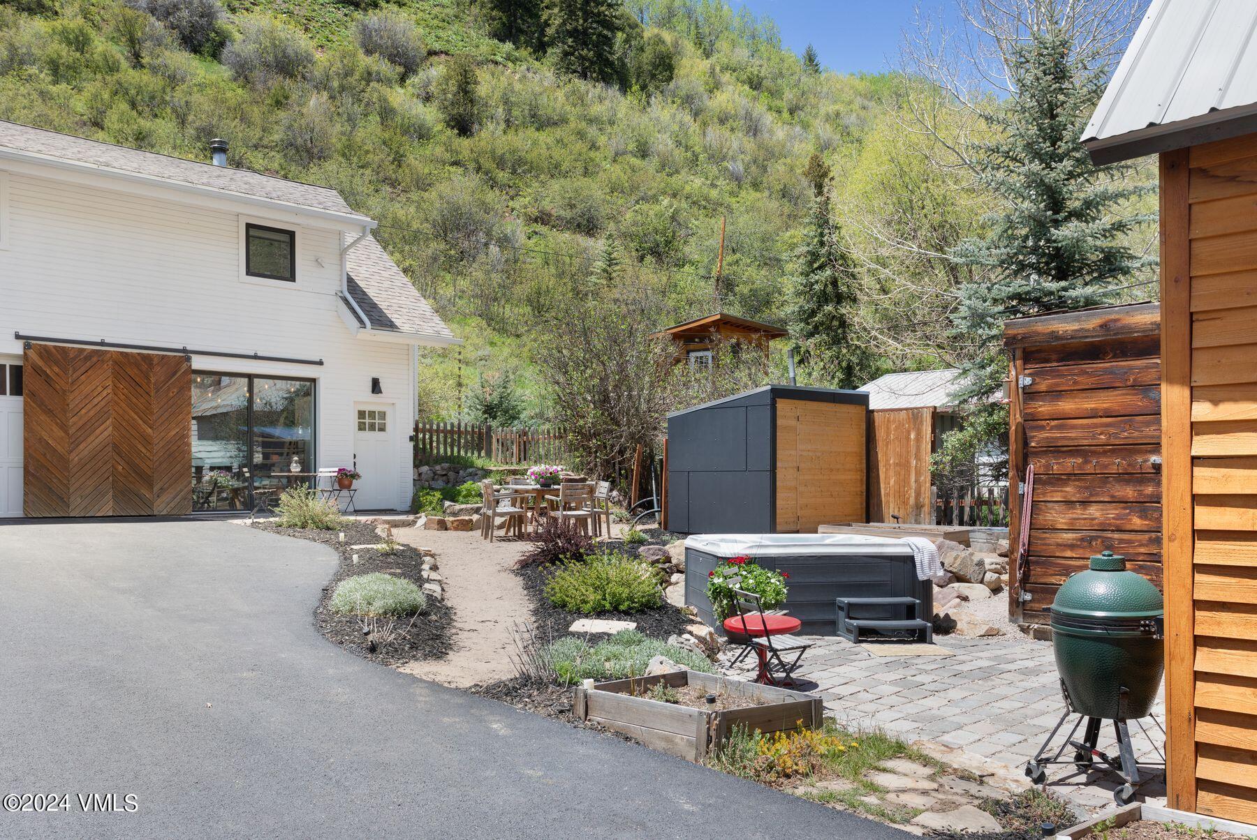 245 Pine Street Minturn, CO 81645 - Photo 22 of 44 a view of a patio with table and chairs potted plants and a house