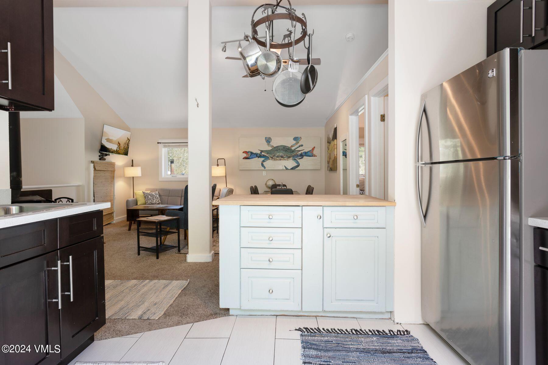 245 Pine Street Minturn, CO 81645 - Photo 33 of 44 a kitchen with a refrigerator and cabinets
