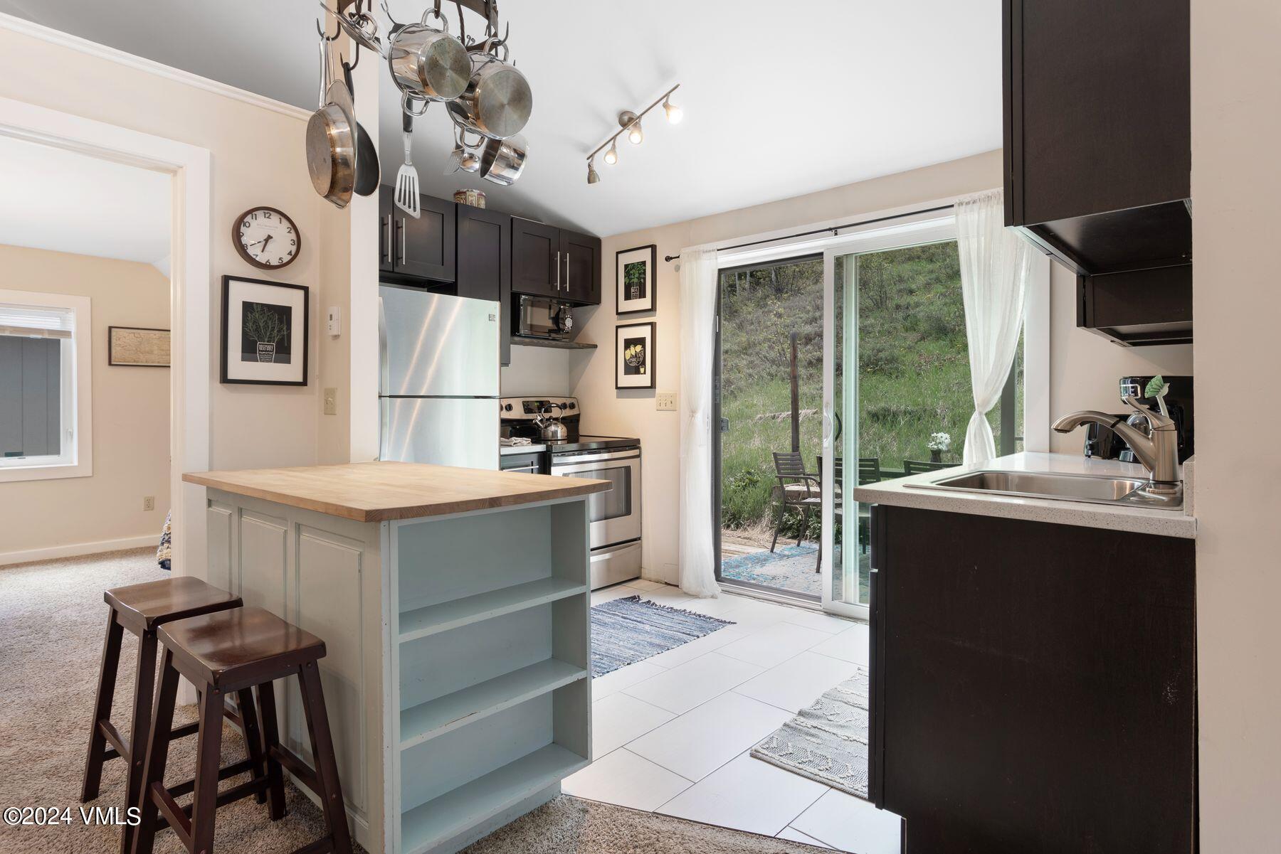 245 Pine Street Minturn, CO 81645 - Photo 34 of 44 a kitchen with a refrigerator and a sink