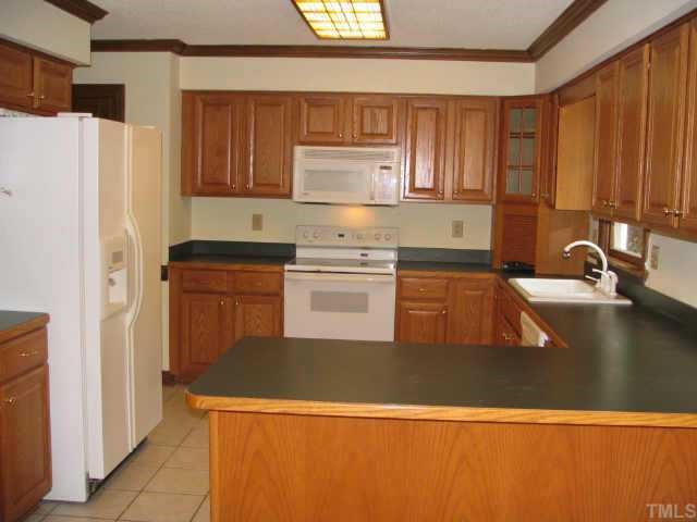 808 Thatcher Way Raleigh, NC 27615 - Photo 2 of 10 a kitchen with stainless steel appliances a refrigerator a sink a stove and white cabinets