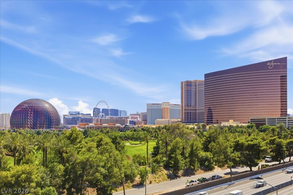 360 East Desert Inn Road, Unit 604 Las Vegas, NV 89109 - Photo 2 of 28 A vibrant cityscape with prominent architectural landmarks under a bright blue sky.