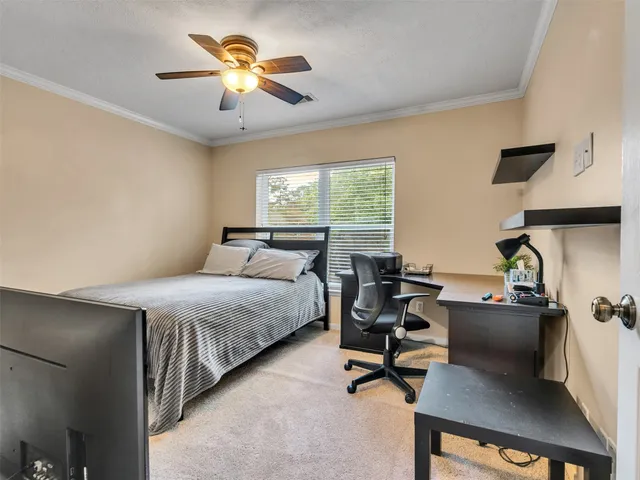 a bedroom with bed and a chandelier