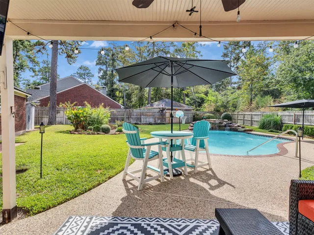a view of a table and chairs under an umbrella