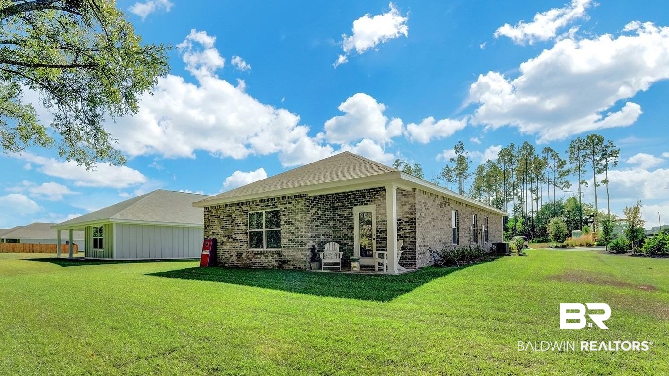 293 Hudson Loop Fairhope, AL 36532 - Photo 30 of 30 Rear view of house featuring brick siding, a yard, and a patio