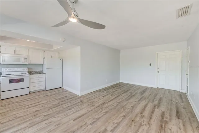 a view of a kitchen with wooden floor
