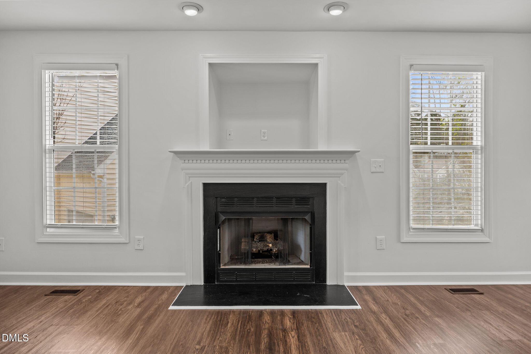 9220 Pennythorne Court Raleigh, NC 27615 - Photo 12 of 49 a living room with a fireplace and wooden floor