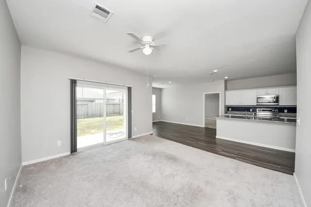 an empty room with windows and closet