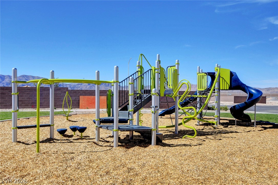 6924 Spicy Merlot Street North Las Vegas, NV 89086 - Photo 60 of 83 A vibrant playground features slides and climbing structures, perfect for active enjoyment.