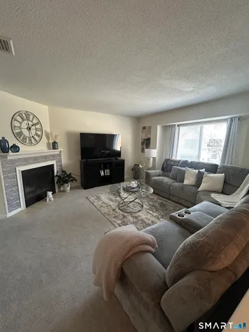 a living room with furniture a window and a fireplace