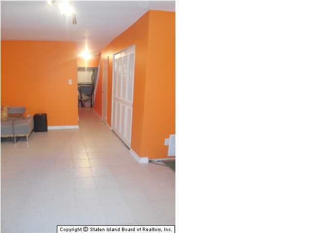 1640 Forest Hill Road Staten Island, NY 10314 - Photo 11 of 20 a view of a hallway with wooden floor