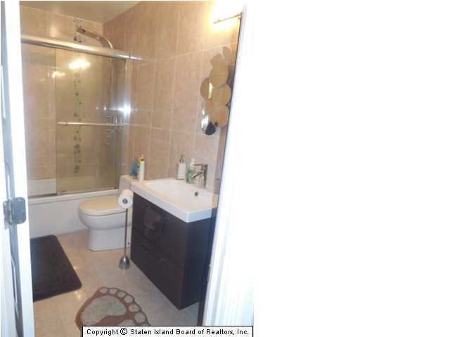 1640 Forest Hill Road Staten Island, NY 10314 - Photo 17 of 20 a bathroom with a sink a toilet and shower