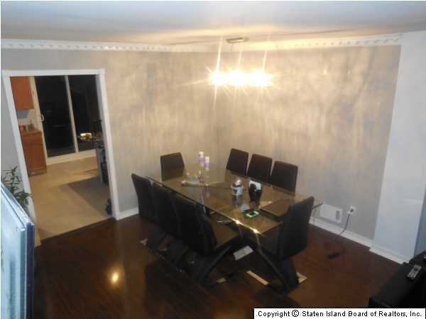 1640 Forest Hill Road Staten Island, NY 10314 - Photo 5 of 20 a view of a dining room with furniture and wooden floor