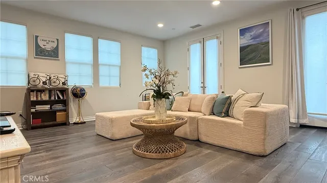 a living room with furniture and wooden floor