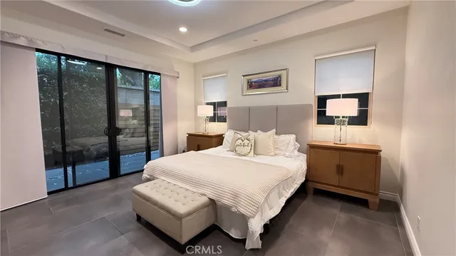 a spacious bedroom with a bed and window