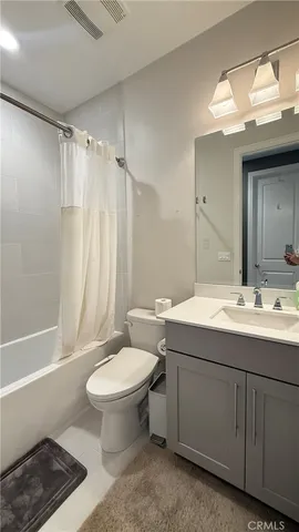 a bathroom with a double vanity sink toilet and shower