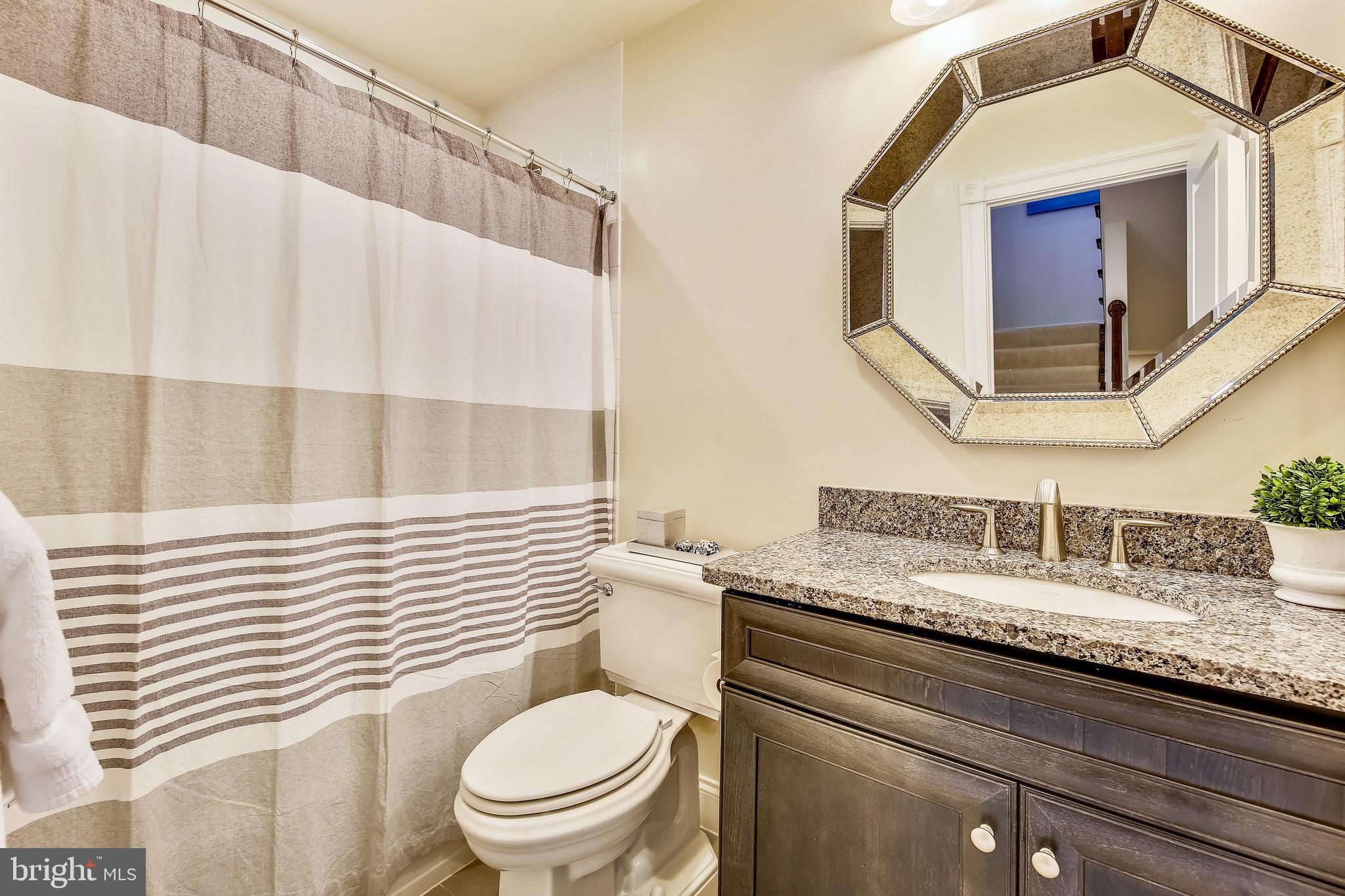 1411 Ridgeview Way Washington, DC 20007 - Photo 23 of 43 a bathroom with a granite countertop sink vanity mirror and toilet