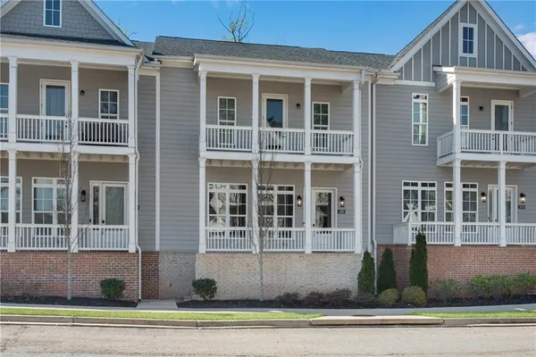 a front view of a house with a parking space