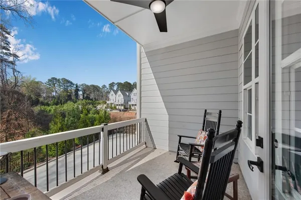 a view of a balcony with wooden floor and fence