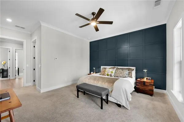 a bedroom with a bed and a large window