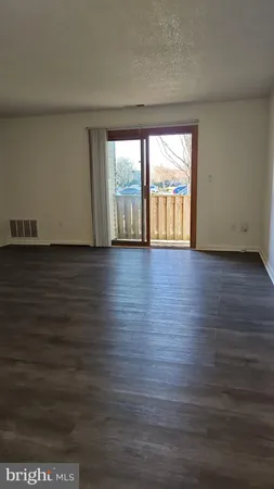 an empty room with wooden floor