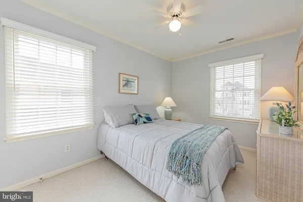 a bedroom with a bed potted plant with the window