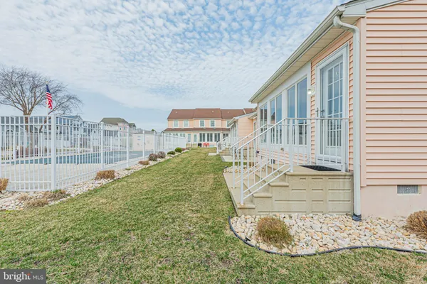 a view of residential houses with yard and play ground