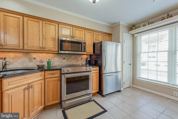 a kitchen with stainless steel appliances granite countertop a stove and a sink