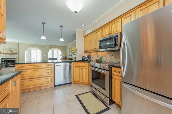 a view of a kitchen with kitchen island wooden floor and window