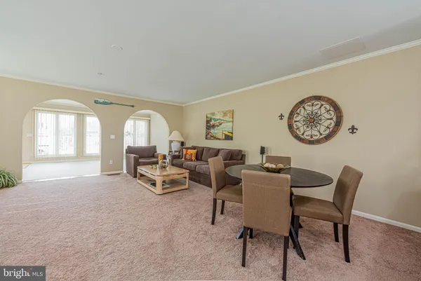 a living room with furniture and a clock