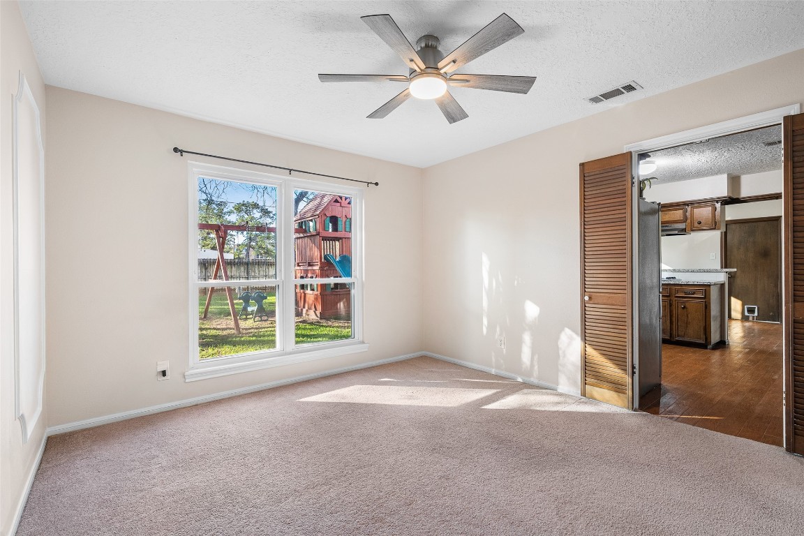723 Shadow Brook Drive Spring, TX 77380 - Photo 12 of 44 an empty room with fan and windows