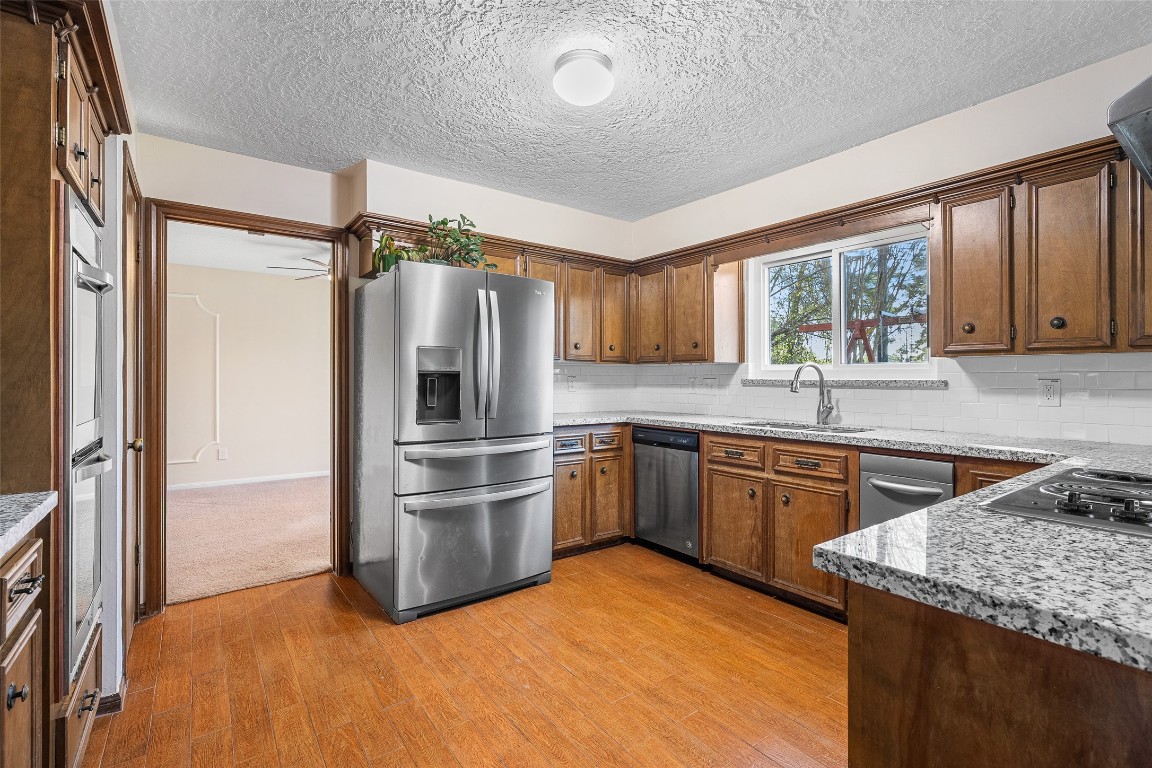 723 Shadow Brook Drive Spring, TX 77380 - Photo 14 of 44 a kitchen with a sink appliances cabinets and a window