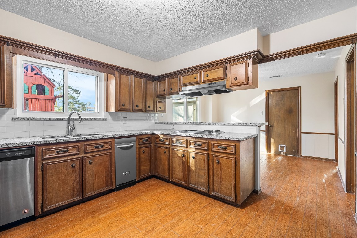 723 Shadow Brook Drive Spring, TX 77380 - Photo 15 of 44 a kitchen with stainless steel appliances granite countertop a stove and a sink