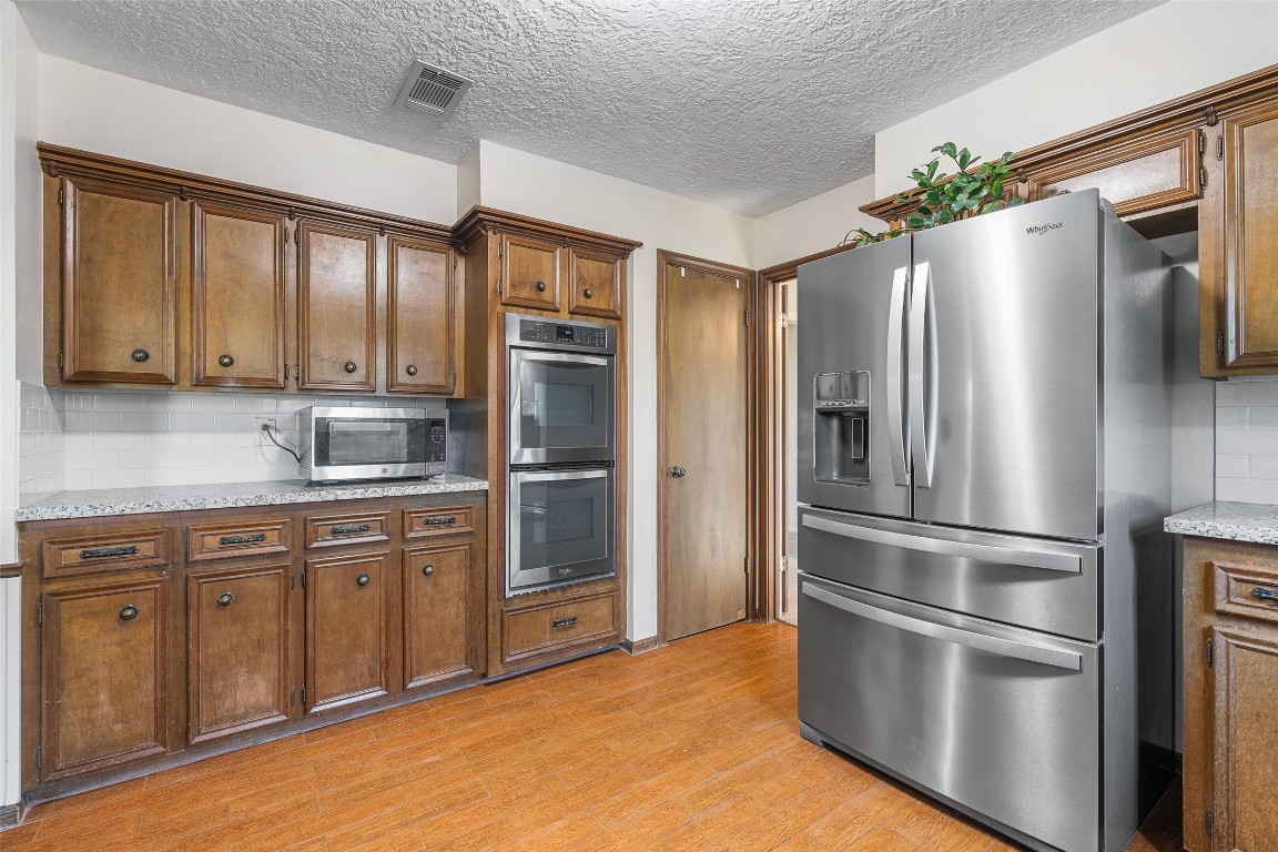 723 Shadow Brook Drive Spring, TX 77380 - Photo 16 of 44 a kitchen with stainless steel appliances granite countertop a refrigerator and a sink