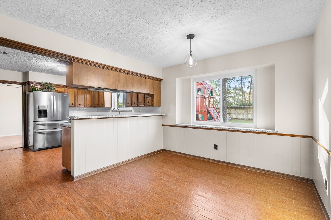723 Shadow Brook Drive Spring, TX 77380 - Photo 17 of 44 a kitchen with stainless steel appliances granite countertop a stove and a refrigerator