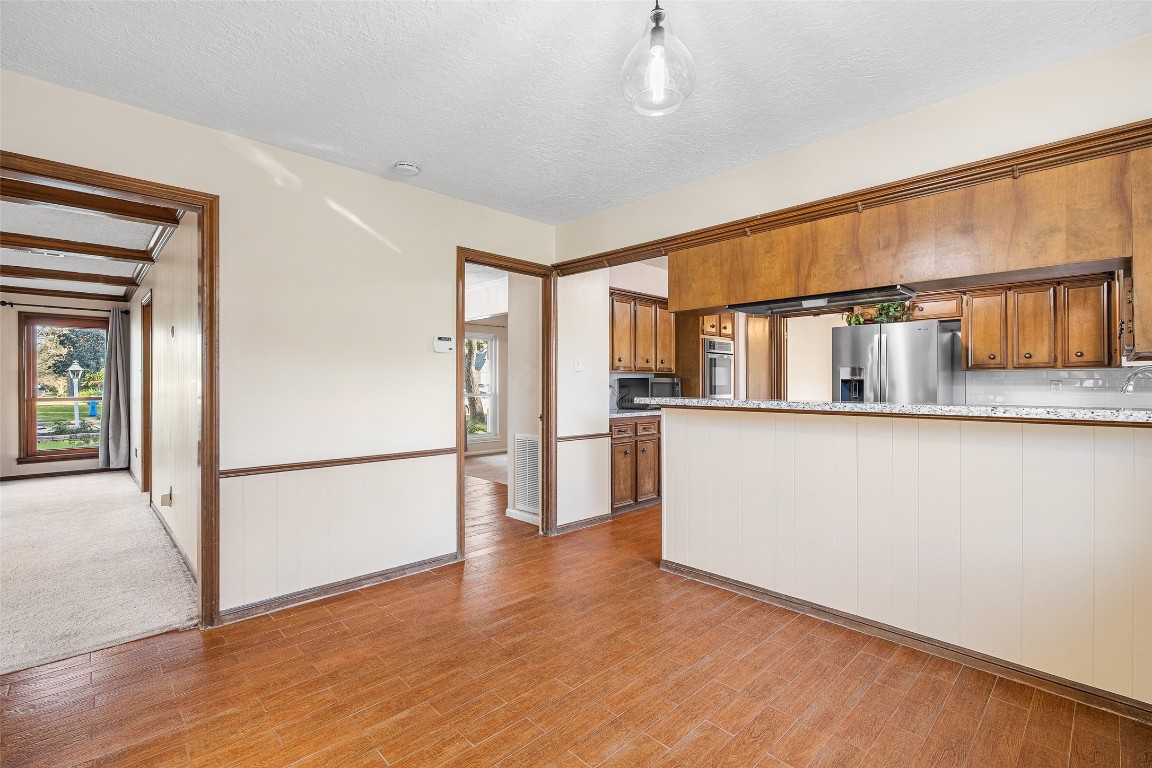 723 Shadow Brook Drive Spring, TX 77380 - Photo 18 of 44 a kitchen with stainless steel appliances granite countertop a refrigerator and a stove top oven