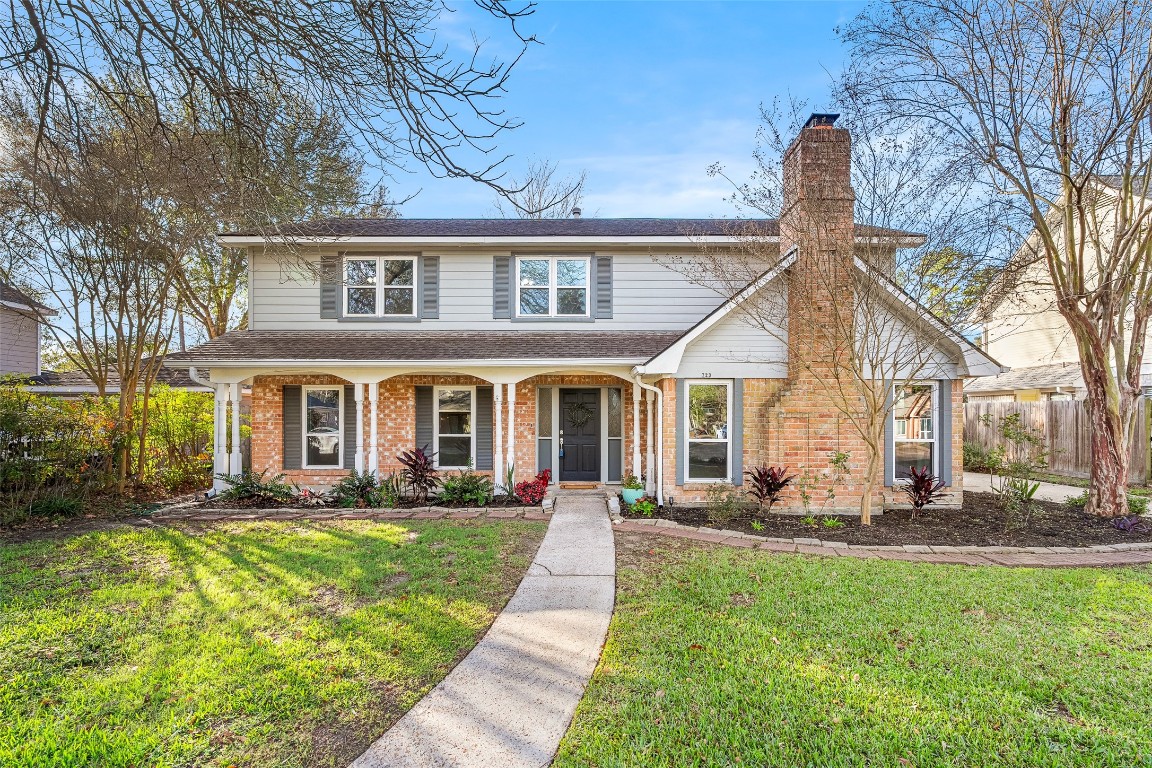 723 Shadow Brook Drive Spring, TX 77380 - Photo 2 of 44 a front view of a house with a yard table and chairs