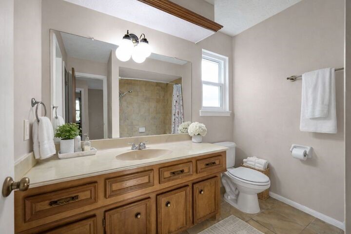 723 Shadow Brook Drive Spring, TX 77380 - Photo 31 of 44 a bathroom with a granite countertop toilet sink and mirror