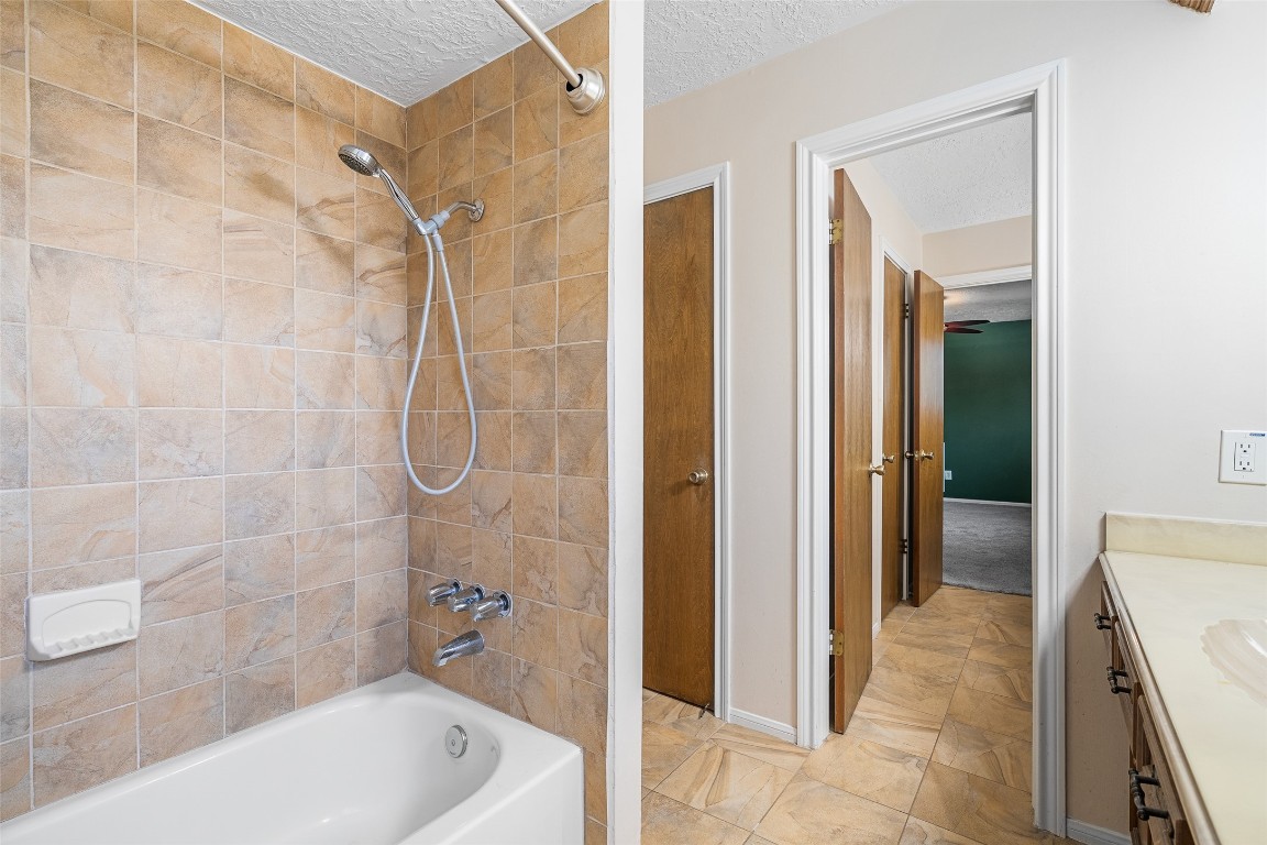 723 Shadow Brook Drive Spring, TX 77380 - Photo 33 of 44 a bathroom with a tub shower and a sink