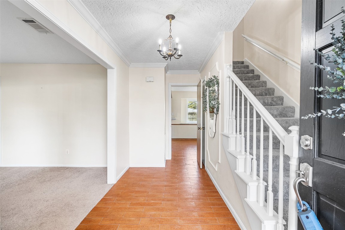 723 Shadow Brook Drive Spring, TX 77380 - Photo 4 of 44 a view of a hallway with wooden floor and staircase