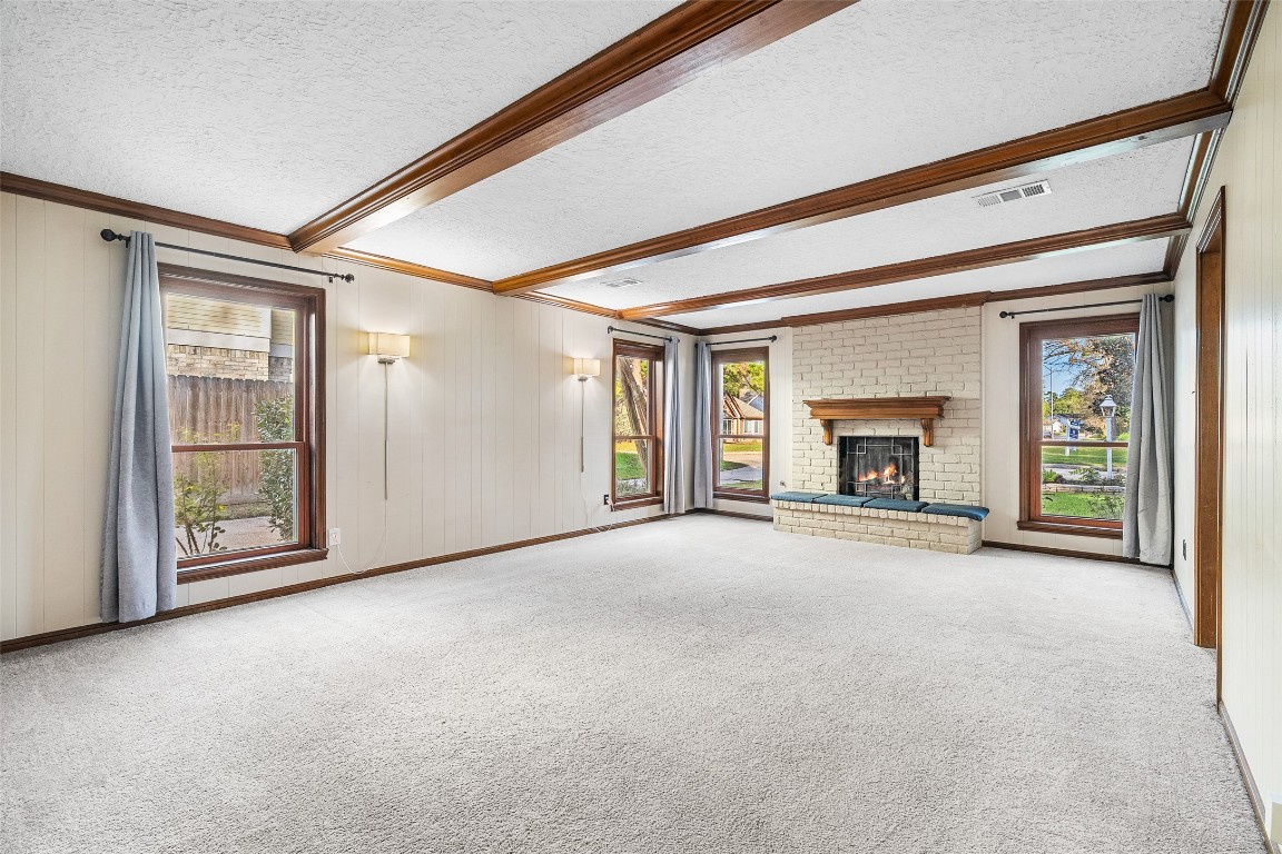723 Shadow Brook Drive Spring, TX 77380 - Photo 7 of 44 an empty room with fireplace and fan