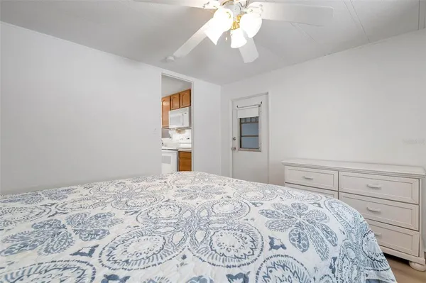 a bedroom with a large bed and a chandelier