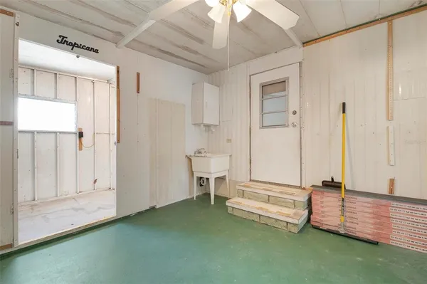 a view of room with wooden floor and white walls